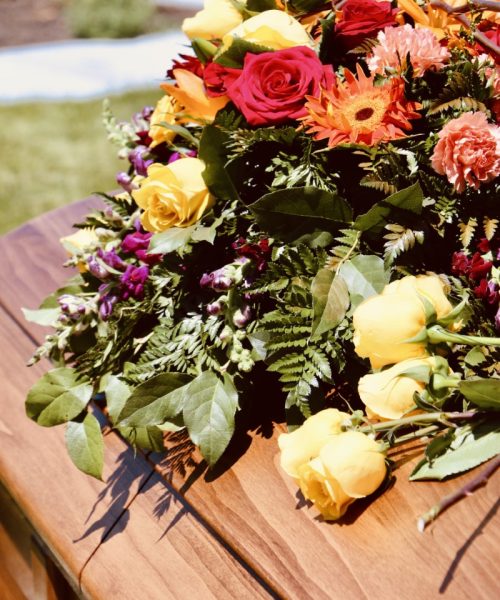 lovely-floral-arrangement-on-wood-casket-2021-09-03-23-26-47-utc (Custom)